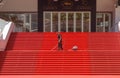 CANNES, FRANCE Ã¢â¬â MAY 19, 2017: A man vacuums the iconic red carpet steps ahead of festivities at the Cannes Film Festival.